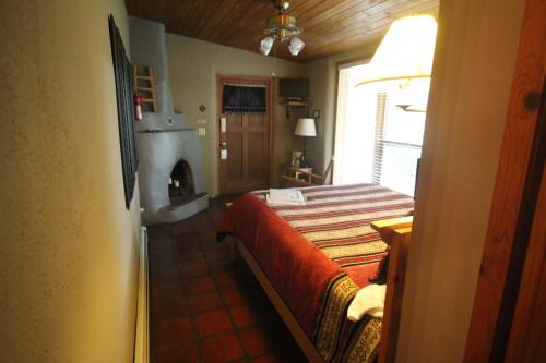 a bedroom with a bed and a fireplace at Dreamcatcher B&B in Taos