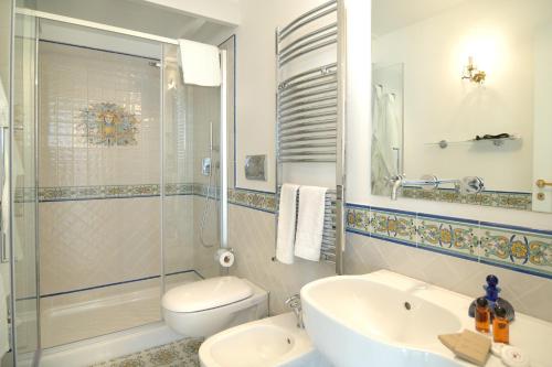 a bathroom with a sink, toilet and bathtub at Residenza Luce in Amalfi