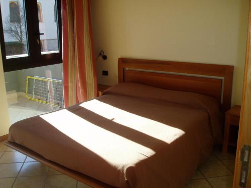 a bed sitting in a room with a window at Miramare Residence in Pozzuoli