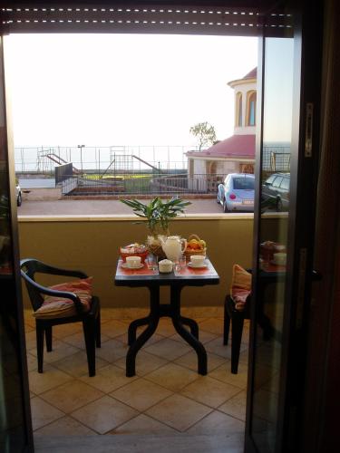 a table with food on top of a balcony at Miramare Residence in Pozzuoli