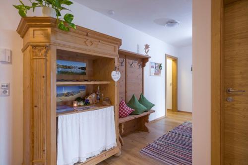 a room with a wooden cabinet with a table in it at Bergsonne in Tux
