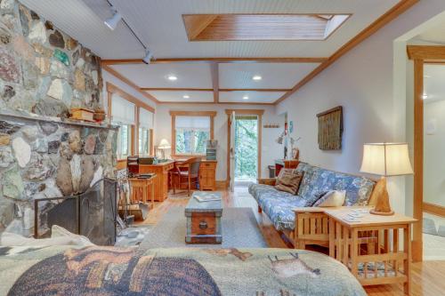 a living room with a stone wall at Eva's Cottage - Romancing the River in Washougal