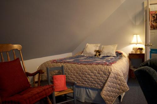 a bedroom with a bed with a dog sitting on it at Artful Lodging & Retreats in Montpelier
