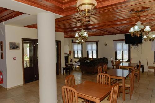 a dining room and living room with a table and chairs at Balkoni Zagoriou in Vradeto