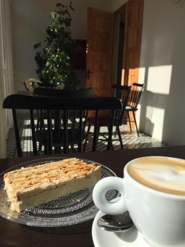 a piece of cake on a plate next to a cup of coffee at Lagar Hotel Boutique in Molina