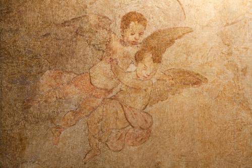 a painting of a woman with a bird on a wall at Hotel Degli Affreschi in Montefalco