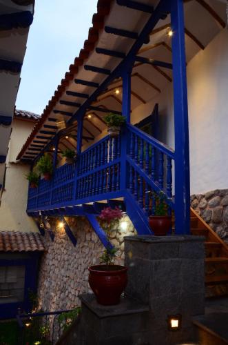 a blue staircase with potted plants on the side of a building at Rumi Wasi in Cusco