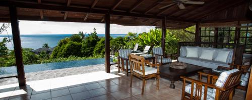 a screened in porch with a view of the ocean at Villas at Stonehaven in Black Rock