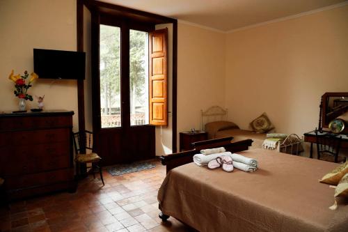 a bedroom with a bed with two stuffed animals on it at Agriturismo Sole di Sicilia in Randazzo