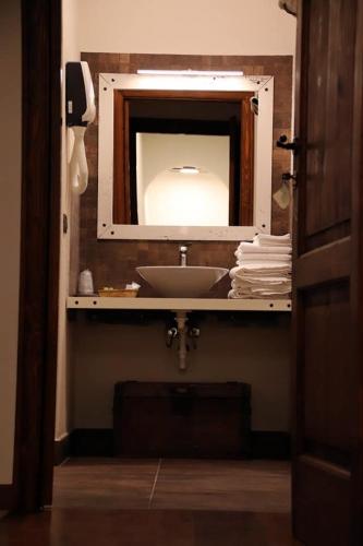 a bathroom with a sink and a mirror at Bed & Breakfast 1906 in San Martino In Strada