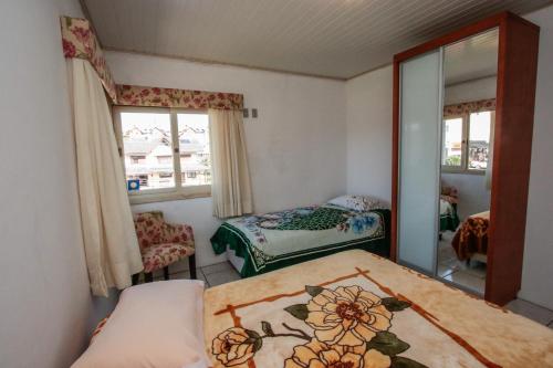 A bed or beds in a room at Apartamento Gramado 01