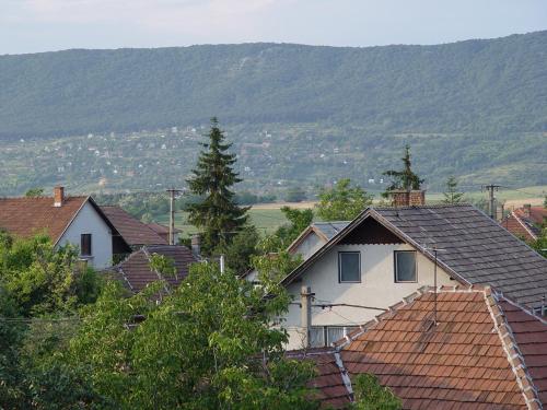 a group of houses with mountains in the background at Edelweiss Panzió in Pilisvörösvár