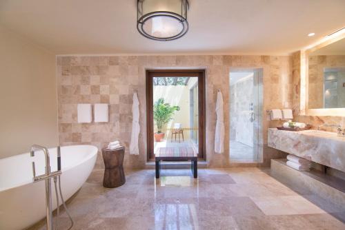 a bathroom with a tub and a sink at Four Seasons Resort Punta Mita in Punta Mita