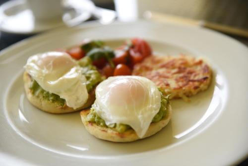 a plate of food with eggs and vegetables on it at Four Seasons Resort Punta Mita in Punta Mita