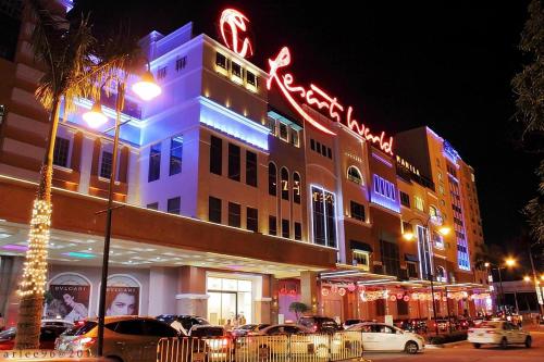a building with neon signs on the side of it at Eighty One Newport Boulevard in Manila