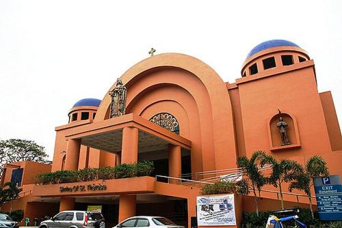 a church with cars parked in front of it at Eighty One Newport Boulevard in Manila