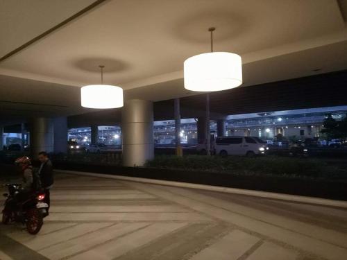 a man on a motorcycle in a building with lights at Eighty One Newport Boulevard in Manila