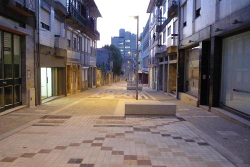 an empty street in a city with buildings at Art Gallery Apartment in Porto