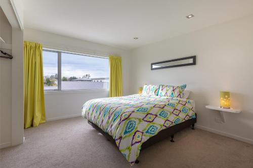 a bedroom with a bed and a window at The Lookout in Mapua