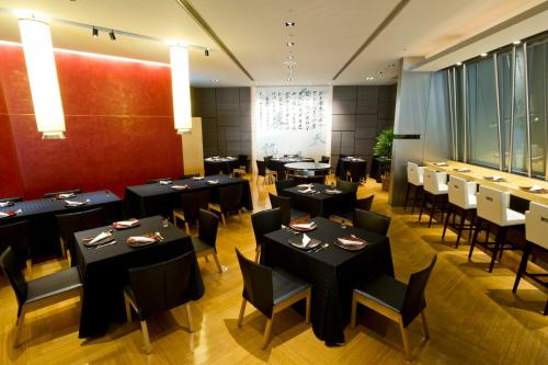 a dining room with black tables and chairs at Cerulean Tower Tokyu Hotel, A Pan Pacific Partner Hotel in Tokyo