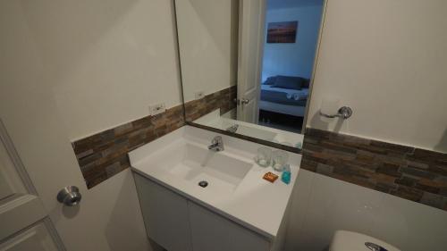 a bathroom with a white sink and a mirror at Hotel Casa Cytia in Cartagena de Indias