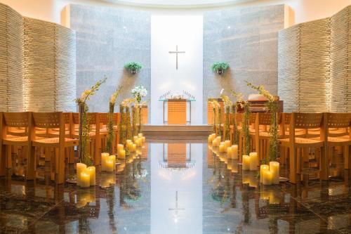 a church with a row of chairs and a cross at Cerulean Tower Tokyu Hotel, A Pan Pacific Partner Hotel in Tokyo