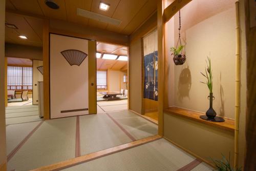 an office corridor with a door and a room at Oyado Tamaki in Shibukawa
