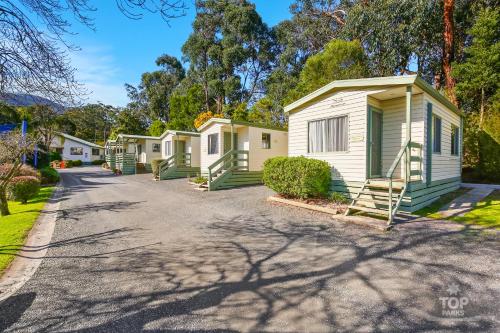 a house on a street with trees at Enclave at Healesville Holiday Park in Healesville