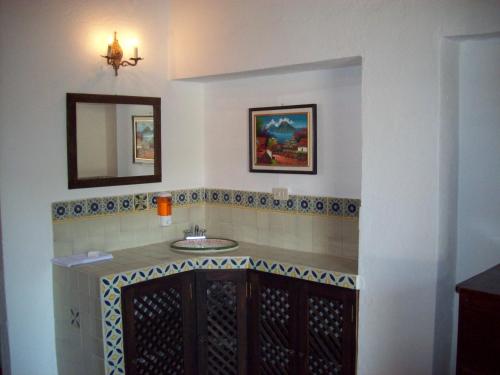a bathroom with a sink and a mirror at Hotel Casa Antigua by AHS in Antigua Guatemala