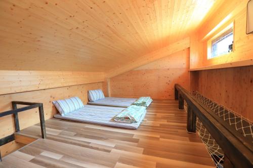 a room with a bed in a wooden cabin at Jama Bay in Xiyu