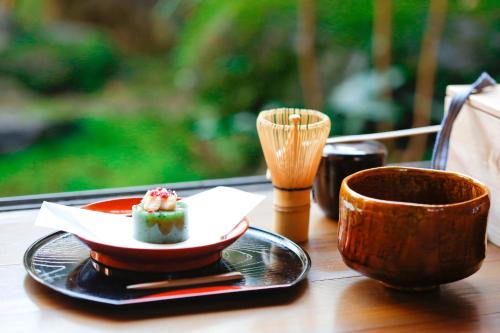 a table with a plate of food and a cup at Matsuharu ANN in Kyoto