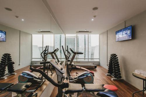 a gym with a bunch of exercise bikes in a room at Janevalla Bandung in Bandung