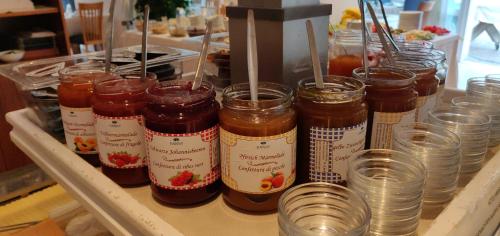 a group of jars of jam sitting on a shelf at Hotel Hanny in Bolzano