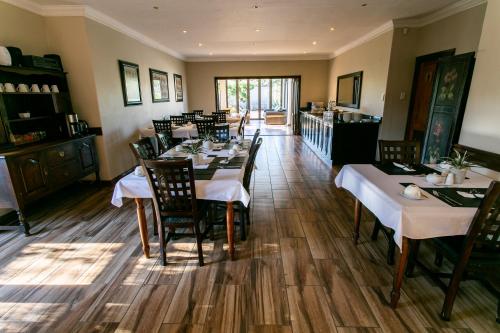 a dining room with a table and chairs in it at Royl Court Guesthouse in Kimberley