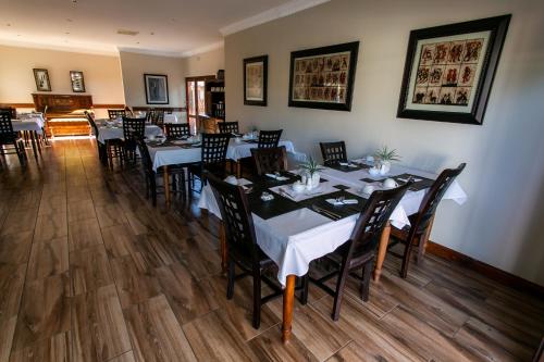 a restaurant with tables and chairs in a room at Royl Court Guesthouse in Kimberley