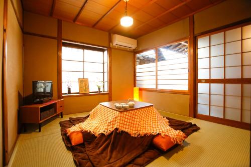 a room with a bed and a table in it at Matsuharu ANN in Kyoto
