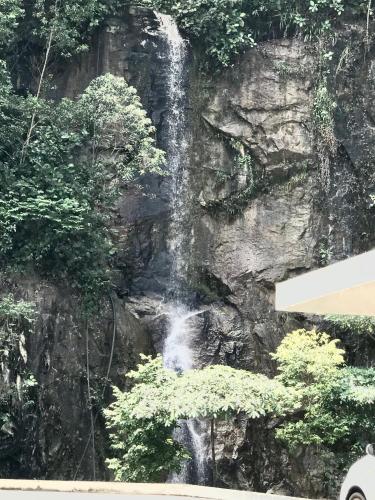 a waterfall on the side of a rock wall at Home Away From Home In Taiping - Newly Upgraded! in Taiping
