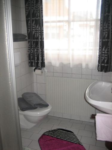 a bathroom with a toilet and a sink at Ad-Capellam in Kappl