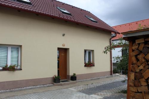 a white house with a red roof at Rivendell Apartments in Prague