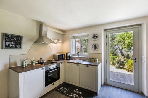a kitchen with a sink and a stove at San Casciano - Appartamenti Podere Ianni in San Casciano in Val di Pesa