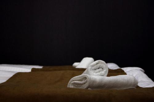 two towels sitting on top of a bed at Suntower Hotel in Mestia