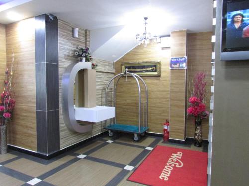 a bathroom with a sink and a mirror and a tv at Safari Hotel in Kuala Lumpur