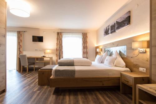 a hotel room with two beds and a television at Der WALZL in Innsbruck
