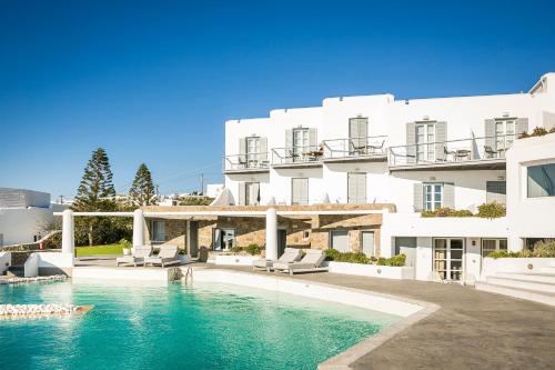 a large white building with a swimming pool in front of it at Ilio Maris in Mikonos