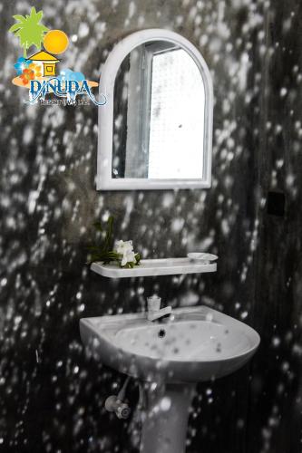 a bathroom with a sink and a mirror at Dinuda Resort in Kalpitiya