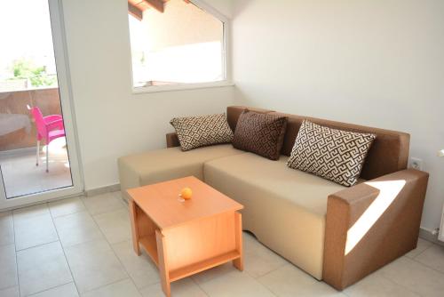 a living room with a couch and a table at Deltix Apartments in Vršac