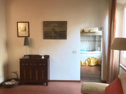 a living room with a door leading to a kitchen at Gino's place in Florence