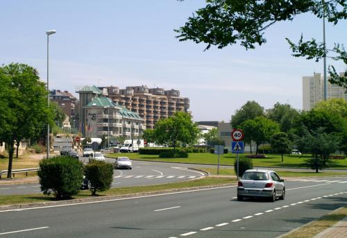 a city street with cars driving down a road at Hotel Palacio del Mar in Santander