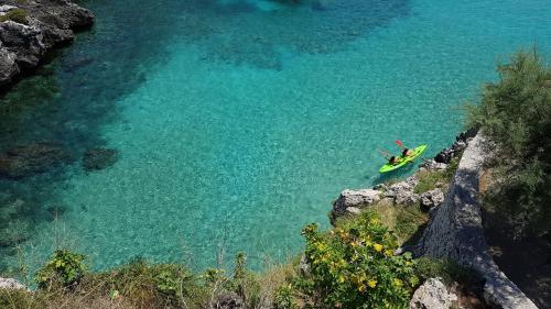a person in a kayak in a body of water at Casa Bellavista in Castro di Lecce