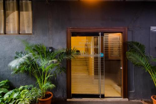 a door to a building with plants in front of it at Hotel Mumbai International in Mumbai